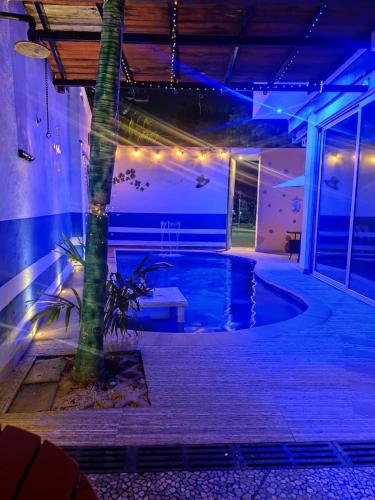 a house with a pool at night with lights at Cancun Hostel para Grupos in Cancún