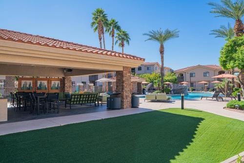 a patio with a table and chairs and a pool at Resort-Style 3RB-2BR-1BR Retreat, Pool, Gym, Parking in Tempe