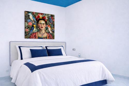 a bedroom with a bed with a painting on the wall at Appartamento Corso Italia 269 in Sorrento