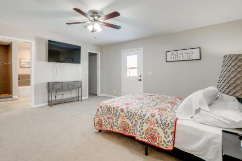 a bedroom with a bed and a ceiling fan at Relax Poolside: Central Group Getaway in Mesa! in Mesa