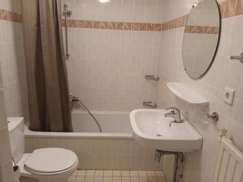 un bagno con lavandino, WC e vasca di Centrum 26 a Brouwershaven