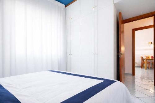 a bedroom with a bed with a blue and white blanket at Appartamento Corso Italia 269 in Sorrento