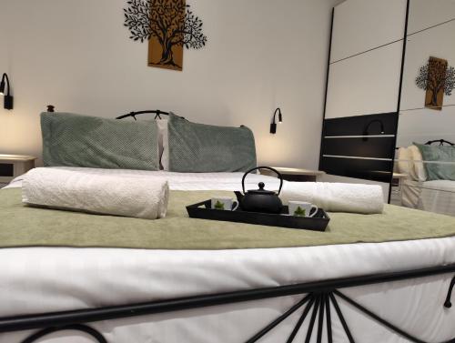a bed with a tea kettle on top of it at Corfu Nature Suites in Corfu