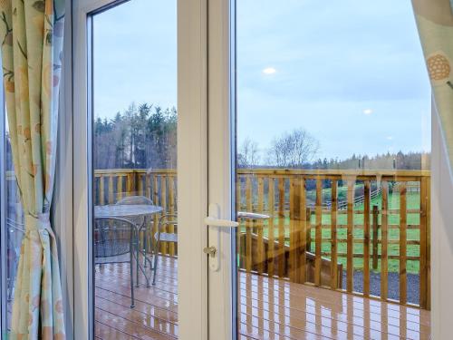 a sliding glass door with a view of a deck at The Paddocks - Uk7112 in Alloa