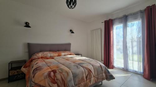 a bedroom with a bed and a large window at B&B Le Tre Vette in Scoppito