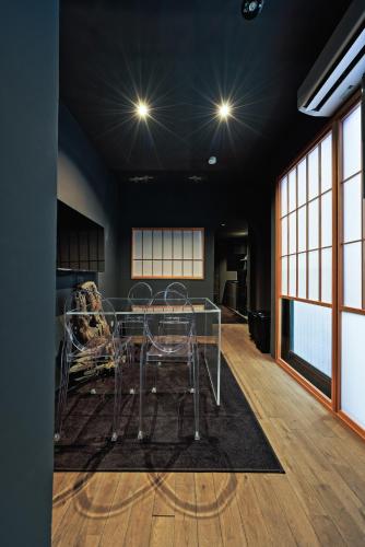 a dining room with a glass table on a rug at NINE plus River with Private Sauna Stay in Kanazawa