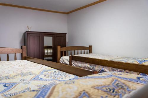 a room with three beds and a cabinet at casa rural Cerro laute in Lanjarón