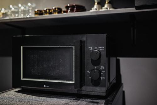 a microwave oven sitting on top of a counter at NINE plus River with Private Sauna Stay in Kanazawa