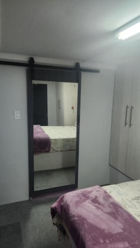 a mirror in a room with a bed and a bedroom at Sand Fontein in Springbok