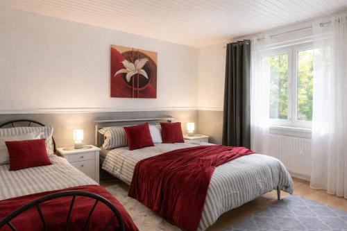 a bedroom with two beds and a window at Black Forest Oase in Gaggenau