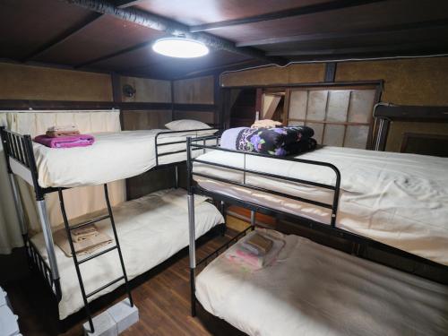 a group of bunk beds in a room at Hikari-Private House in Tokyo