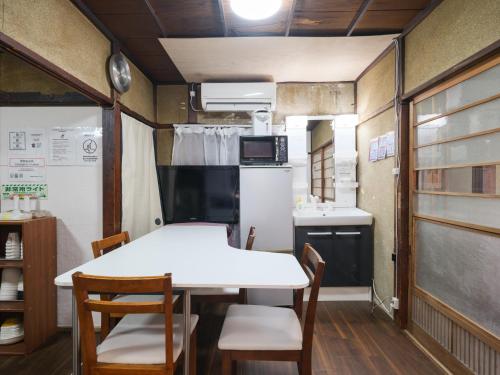 a kitchen and dining room with a table and chairs at Hikari-Private House in Tokyo