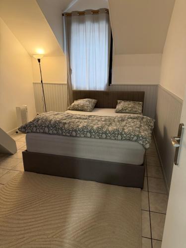 a bedroom with two beds in a small room at T3 duplex Cosy Centre-ville Longjumeau Proche RER TGV Orly in Longjumeau