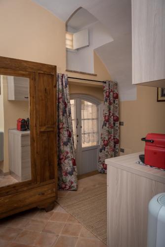 a kitchen with a wooden door and a window at Residence Fusconi in Norcia