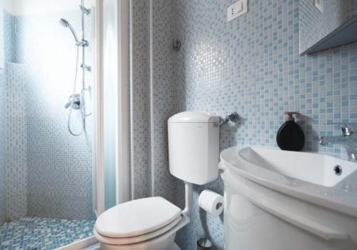 a bathroom with a white toilet and a sink at Apartment 2 in Venice