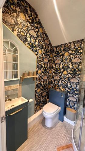 a bathroom with a toilet and a sink at Garden Galley Nook in Sproatley
