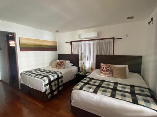 a bedroom with two beds in a room at Coras Place Bacalar Lagoon front in Bacalar