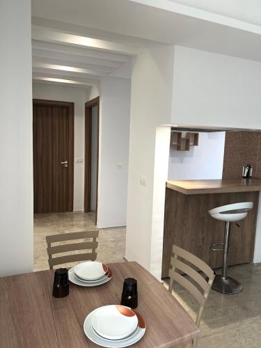 a dining room with a table with plates on it at Comfortable and Fresh Apartment in Tunis