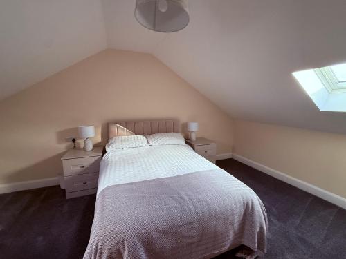 a bedroom with a white bed and a window at Four Bedroom House With Private Pool - Stunning countryside location with parking close to Chester City Centre in Chester