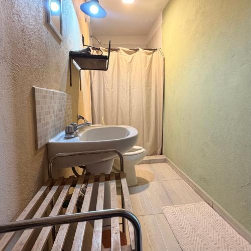 a small bathroom with a sink and a toilet at West Refugio in San Juan del Río