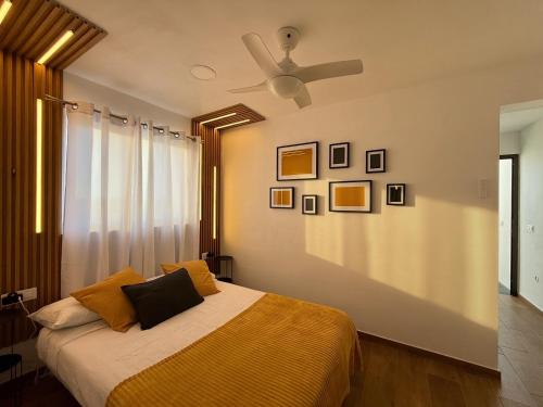 a bedroom with a bed with a ceiling fan at Candela 2 en candelaria in Candelaria