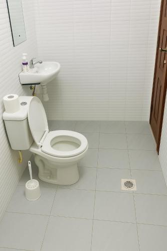a bathroom with a toilet and a sink at JOJO Staycations in Rungiri