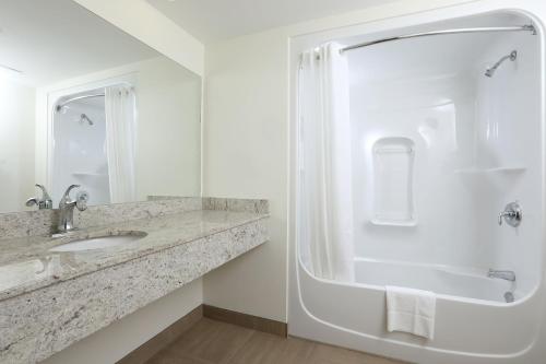 a bathroom with a sink and a shower at Canad Inns Health Sciences Centre in Winnipeg