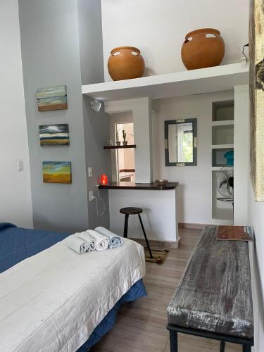 a bedroom with a bed and a table and shelves at Casa laberinto, Entre cerros, cómoda cama de 2x2 in Salta