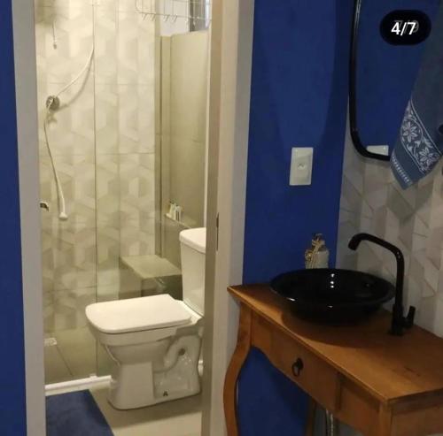 a bathroom with a toilet and a sink and a shower at Hostel SIL CARDOSO in Blumenau