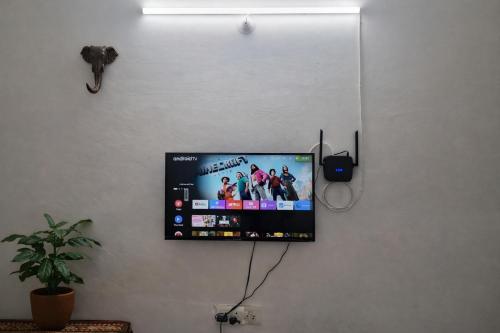 a flat screen tv hanging on a wall at 1 Bhk Mayra Homes in Raipur