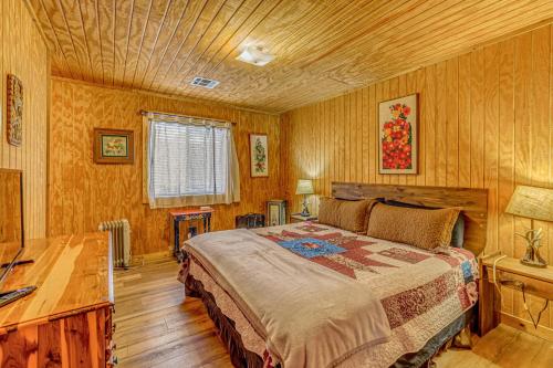 a bedroom with a bed and a wooden ceiling at Peaceful & Private Cloudcroft Cabin with Deck! in Cloudcroft