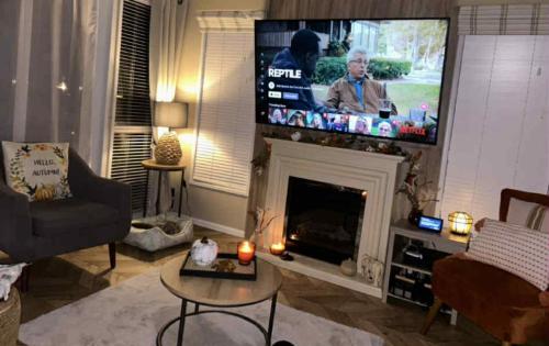 a living room with a fireplace and a flat screen tv at sunset luxury lakeside lodge with hot-tub,3 bedrooms, pet friendly in Tattershall