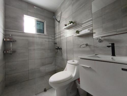 a white bathroom with a toilet and a sink at América Colares VII in Los Frailes
