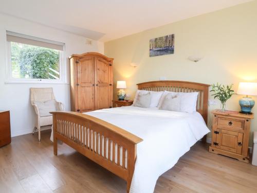 a bedroom with a large white bed and a window at Castle View Lodge in Ilfracombe