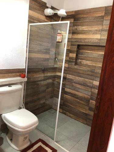 a bathroom with a shower with a toilet at Chalé Pitanga in Pôrto de Pedras