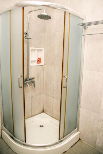 a shower with a glass door in a bathroom at Hotel Mount Pleasant in Bandarawela