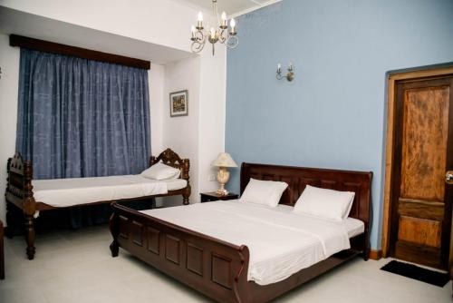 a bedroom with two beds and a window at Hotel Mount Pleasant in Bandarawela