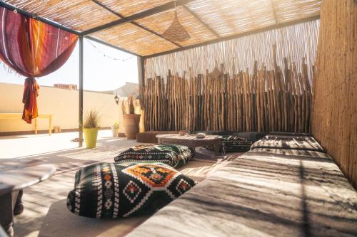 a room with several beds and pillows on the floor at Eco Bay Surf Camp in Aourir