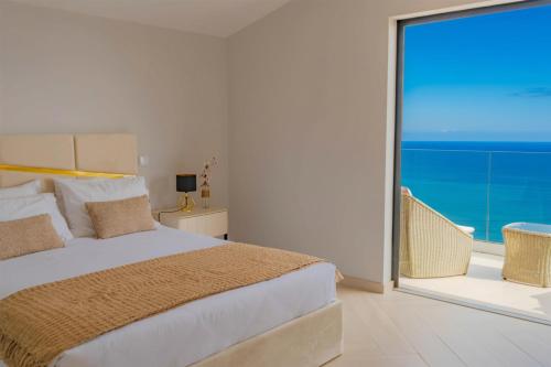 a bedroom with a bed and a large window at Ocean View Villa, Private Pool and Terrace in Santa Cruz