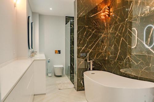 a bathroom with a toilet and a shower and a sink at Ocean View Villa, Private Pool and Terrace in Santa Cruz