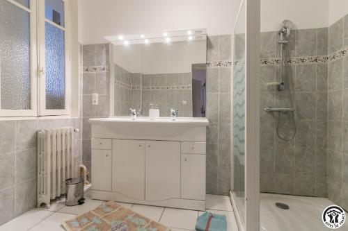 a bathroom with a sink and a shower at Maison de Marius et Maison d Amelie in Esténos