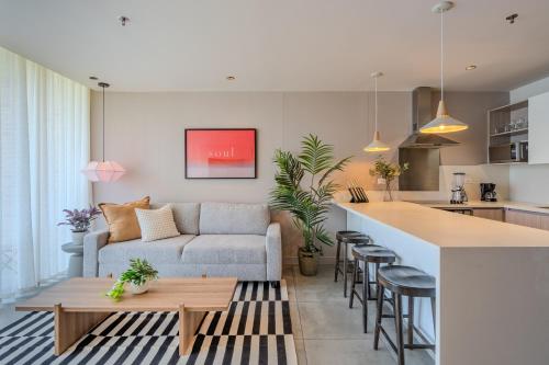a living room and kitchen with a couch and a table at Soul Lifestyle Hotel in Medellín
