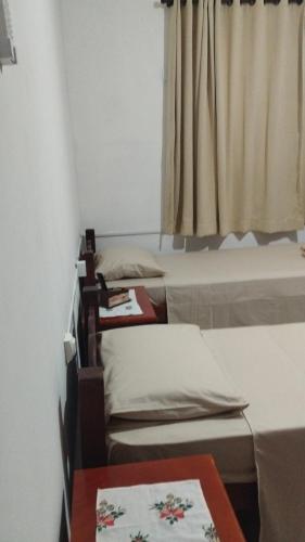 a room with three beds and a window at Bonito é ser Feliz Budget in Recife