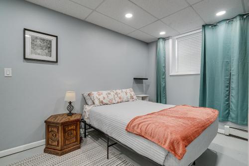 a bedroom with a bed and a nightstand and a window at Downtown Casper Gem! Super Walkable Apartment in Casper