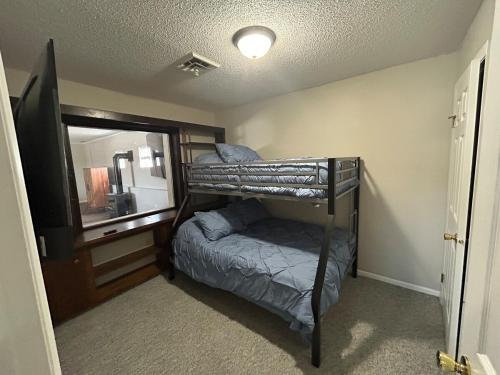 a bedroom with a bunk bed and a mirror at The Palace in Mandan
