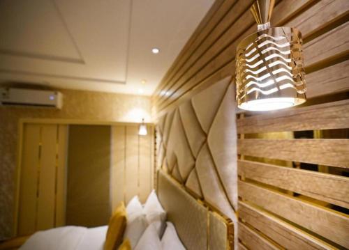 a room with a bed and a light and a bed sidx sidx sidx at Lambert ApartHotel in Jeddah