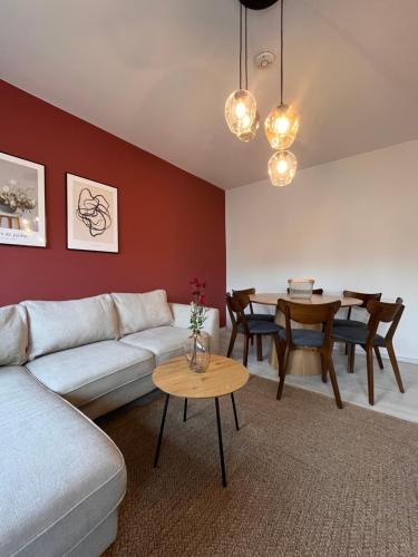 a living room with a couch and a table at Neues 3-Zimmer-City-Apartment in Bielefeld mit Espresso, Arbeitsplatz und Parkplatz in Bielefeld