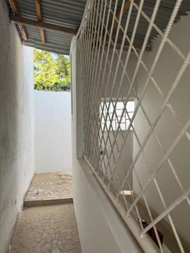 a room with a jail cell with a door at Simple house in Lyndiane Zig in Ziguinchor