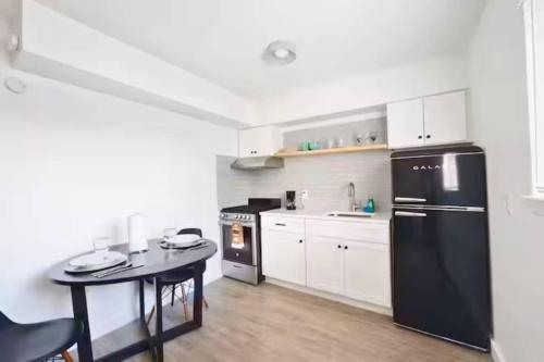 a kitchen with a black refrigerator and a table at Cozy 1BR Apartment in Phenomenal Austin - Minutes to Downtown in Austin