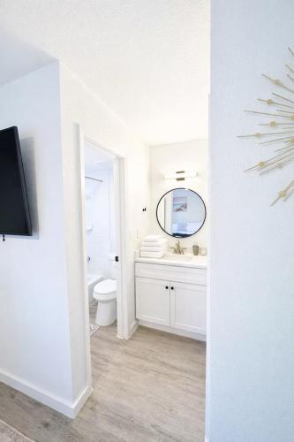 a white bathroom with a sink and a mirror at Cozy 1BR Apartment in Phenomenal Austin - Minutes to Downtown in Austin